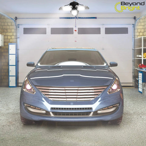 Beyond Bright LED Ultra Bright Garage Light With Three Adjustable Panels illuminating a garage with a parked car underneath.