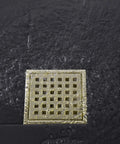 4 Inch Square Shower Drain With Adjustable Base Flange In SUS 304 Stainless Steel Removable Grid Cover Sleek Brushed Gold Finish Scratch Resistant Floor Drain For Bathrooms And Showers Easy Clean Upgrade For Modern Wet Areas on black tile floor