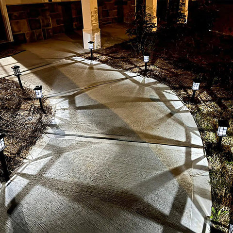 Solar Pathway Lights Outdoor LED Solar Powered Garden Lights illuminate a curved walkway at night, showing IP44 weatherproof design.