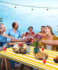Group enjoying meal on outdoor table with Stripe Picnic Table Cover Set With Bench Covers 72 X 30 Inch Fitted Waterproof Vinyl Tablecloth.