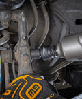 Mechanic using 13 Piece One Half Inch Drive 6 Point Impact Socket Set SAE Heavy Duty CrMo Steel on car suspension
