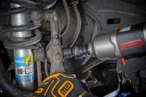 Mechanic using 13 Piece One Half Inch Drive 6 Point Impact Socket Set SAE Heavy Duty CrMo Steel on car suspension