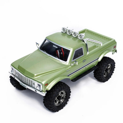 Badass 1/18 Scale RC Crawler With Slick Shifting Two Speed Transmission And Bulletproof Metal Gears Nasty Terrain Rock Climbing Rig Trail Smashin Setup Drop In Ready Convoy Medium Olive Green from above showing chrome details and large tires.