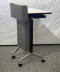 Rock Solid Portable Podium Stand With Quick Tilt Locks And Heavy Duty Casters That Roll Smoothly for Lectures, gray with casters and sturdy surface.