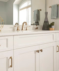 White cabinet with Golden Champagne Cabinet Cup Pulls Set Of 10 With 3 Inch Center To Center Spacing And About 3.44 Inch Overall Length Classic Traditional Style Hardware For Cabinets And Drawers Upgrade Your Kitchen Or Furniture With A Slick Luxe Vintage Vibe, in a modern bathroom setting.