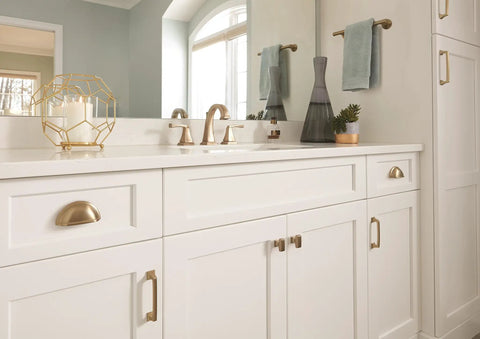 White cabinet with Golden Champagne Cabinet Cup Pulls Set Of 10 With 3 Inch Center To Center Spacing And About 3.44 Inch Overall Length Classic Traditional Style Hardware For Cabinets And Drawers Upgrade Your Kitchen Or Furniture With A Slick Luxe Vintage Vibe, in a modern bathroom setting.