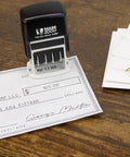 Slick S120 Self Inking Date Stamp With Black Ink And Half Inch Impression Size featuring date imprint on a check.