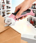 Heavy Duty Cordless Electric Scissors With Fast Usb Rechargeable Power And Self Sharpening Steel Blades For Slick Cuts Through Denim Fabric Leather Carpet And Stubborn Cardboard In Nifty Pink cutting through cardboard with ease.
