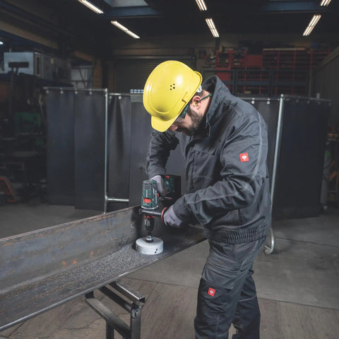Worker using an 18V Cordless Driver Drill Kit Handles Heavy Demands With Two 18V 5.5Ah Batteries And A Badass Tool Free Quick Change Chuck.