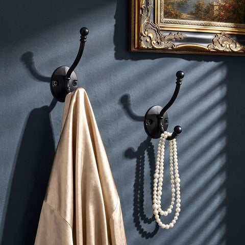 Heavy Duty Black Wall Mounted Coat Hooks 10 Pack With Complete Hardware Kit No Fuss Setup, displaying a coat and pearls.