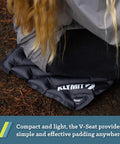 Person sitting on V Seat Inflatable Cushion For Travel, Camping, Backpacking And Bleachers, Portable Comfy Padded Seat.