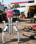 Heavy Duty Hydraulic 3 Jaw Bearing Puller Built Like A Tank With 15 Ton Hub Separation Power Rust Proof Alloy Steel Body in workshop setting.