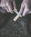 Person using Six Pcs Diamond Sharpening Hones Set With Color Coded Diamond Stones For Hunting And Outdoor Use.