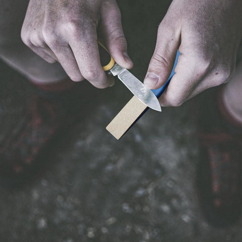 Person using Six Pcs Diamond Sharpening Hones Set With Color Coded Diamond Stones For Hunting And Outdoor Use.