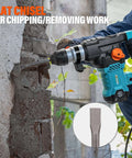 Side view of Amazon Berserker SDS-Plus rotary hammer drill with flat chisel bit chipping concrete