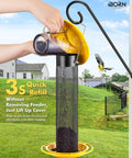 Outdoor Finch Feeder For Nyjer Seed Tube With Metal Mesh 13 Inch Length Weatherproof Roof And Tray 2 Lb Capacity Hanging Bird Feeder For Backyards Yellow being refilled outdoors.