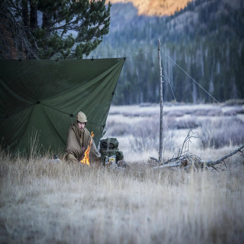 Camper under Supertarp Tarp Shelter In Pencott Wildwood Camo, Waterproof Ripstop Overland Camping Gear For Serious Weather