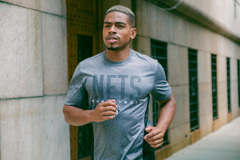 Man jogging in Officially Licensed NBA San Antonio Spurs Tee For Men Women Heather Charcoal Super Soft Supreme Unisex Comfort Fit