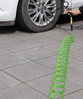 Kickass Polyurethane Recoil Air Compressor Hose 1/4 Inch By 50 Feet in use with tire pressure gauge on a car wheel.