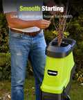 Man using Electric Wood Chipper And Shredder With 15 Amp Motor, 1.8 Inch Cutting Capacity in garden