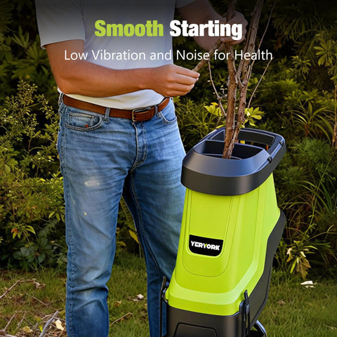 Man using Electric Wood Chipper And Shredder With 15 Amp Motor, 1.8 Inch Cutting Capacity in garden