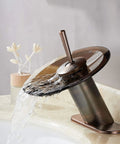 Oil Rubbed Bronze Waterfall Bathroom Sink Faucet With Brass Modern Circle Glass Disk Rinser in operation on a marble sink