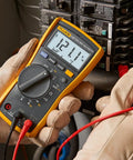 Compact On-The-Go True RMS Multimeter For Field Technicians With Voltage And Current Measurement in use by technician