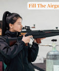Person filling airgun using Carbon Fiber 6.8L PCP Air Tank For Paintball And HPA, 414 Cu In Capacity, 300 Bar 4500 PSI