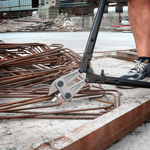 Beefy 30 Inch Heavy Duty Bolt Cutter With Chrome Molybdenum Jaws And Soft Rubber Grips cutting metal rods on construction site