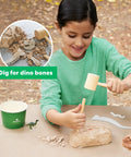 Dinosaurs Fossil Dig Kit For Kids Ages 6 And Up, Real World Science Excavation And Skeleton Assembly, Dig Up Bones, Build A Full Dino Replica With Mini Dinosaurs, Modeling Clay, Plaster, And Geologic Timescale Facts Poster; child digging fossil block