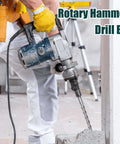 Side view of blue SDS Plus rotary hammer drill with a 59-inch masonry bit drilling into concrete.