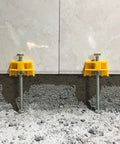 Tile Leveling System Kit With Portable Lifting Tool, adjustable height locators on a floor, supporting two tiles, 5mm to 90mm range.