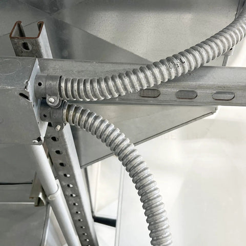 Three Quarters Inch Galvanized Steel Flexible Electrical Conduit 25 Ft Roll connected in metal framework