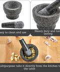 Compact Granite Mortar and Pestle 3.75 Inch Bowl for Spices and Herbs shown with garlic cloves on a wooden table.