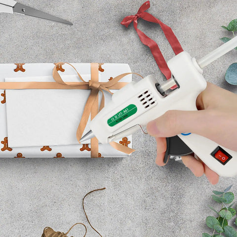 Dope Mini Hot Glue Gun Kit With 30 Glue Sticks used to wrap a gift, showing compact white design and precision nozzle.