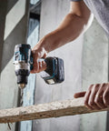 Brushless 18V Cordless Drill Driver With 13Mm Keyless Chuck And Dual Speed Gearing, drilling through wood.