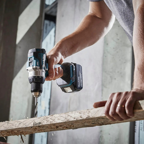 Brushless 18V Cordless Drill Driver With 13Mm Keyless Chuck And Dual Speed Gearing, drilling through wood.