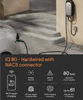 64 Amp Hardwired Level 2 EV Charger With WiFi, 25ft Rugged Cable, Tesla NACS Compatible, mounted on outdoor wall near car