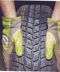 Hands in work gloves holding a winter tire with 200 Piece Winter Tire Studs Heavy Duty Skid Screws Tungsten Snow Spikes installed.