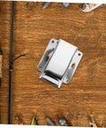 Front view of stainless steel fish cleaning clamp with mounting flanges on wooden workspace.