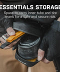 Hands holding Elementa Seatbag M Under-Saddle Bike Bag 0.5 Liter with inner tube and tire levers visible inside, detail view.