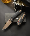 Dope Rose Gold Folding Knife for Men and Women with G10 handle and PVD finish on a box, open and closed view.