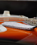 Nomad String Body And Hardware Cleaning Tool For Guitars And Bass Extends String Life, Preserves Tone, And Cleans Strings, Body, And Hardware In Seconds With A Premium Microfiber Pad No Cleaning Solution Needed on orange guitar strings