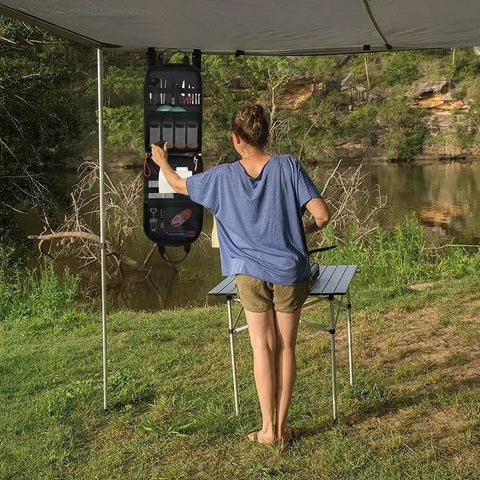 Person using High Capacity Camp Kitchen Organizer Bag With Hanging Hooks And Paper Towel Holder Waterproof Multi Pocket Portable Storage For BBQ