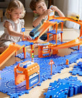 Two kids playing with Totally Cool Puzzle Race Car Track Set for Kids Ages 3 to 8 DIY Floor Car Track Toy with turns and ramps