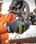 Person wearing Heat Worx Heavy Duty FR Fire Resistant Gloves For Handling Hot Stuff Up To 600°F, operating machinery.