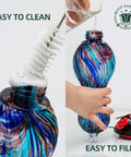 Outdoor Hand Blown Glass Hummingbird Feeder With 24 Oz Capacity And Four Feeding Ports being cleaned and filled.