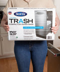 Person holding a box of Heavy Duty Trash Bags For Rectangular Canisters That Can Handle It All 16 Inch Deep 9 Inch Wide 17 Inch High Pack Of 24 Wet Strength Paper Liner With Reinforced Bottom Seal Pre Cuffed Made In USA in a kitchen.