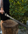 Person holding Hand Forged Knight Sword In Spring Steel 35 Inch Full Tang Medieval Blade Built For Realistic Battle Vibe