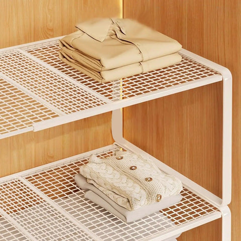 Closet Shelf Organizer Metal Storage Rack For Home Wardrobes with folded linens on white iron shelves against wood wall